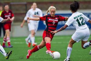 Senior soccer player Summer Khalil dribbles the ball during the Westside girls soccer team's game against Millard West in the first round of the state tournament last year, when Khalil was a junior. Khalil is going Division I for soccer.