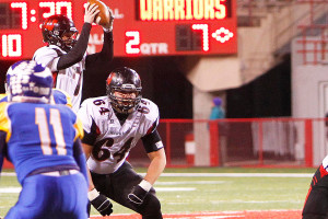 Senior Tom Young prepares to block an Omaha North defender as senior Christian Hagan takes a snap during the football state championship Tuesday, Nov. 26. Young and Hagan both signed on National Signing Day 