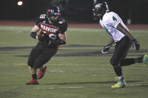 Senior Matt Connelly carries the ball in the Warriors game against Benson. Connelly is one of the seven Westside football players to sign on National Signing Day